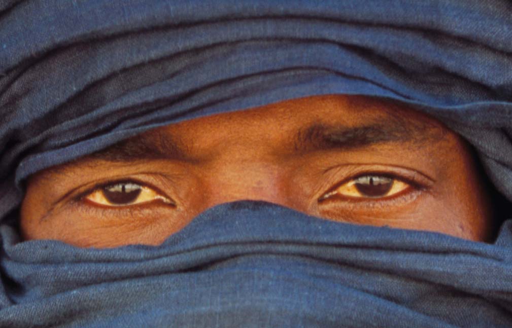 The face of a Libyan Tuareg in a blue veil leaving only his eyes uncovered.